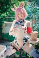 A woman in a cow costume sitting on a chair.